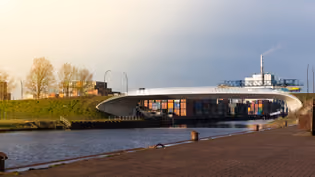 Modern bridge crossing a canal, illustrating structural design and transport integration in civil engineering.
