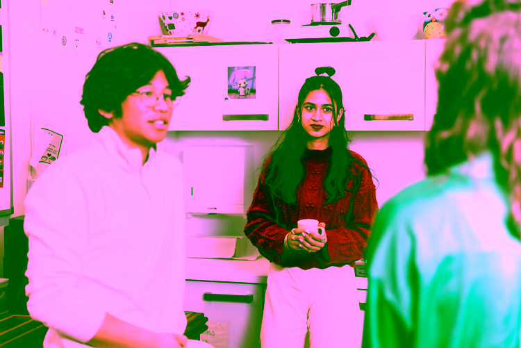 Three students standing in the kitchen of a student house at the campus of the University of Twente