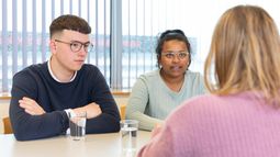 Students at table talking about Conflict, Risk & Safety