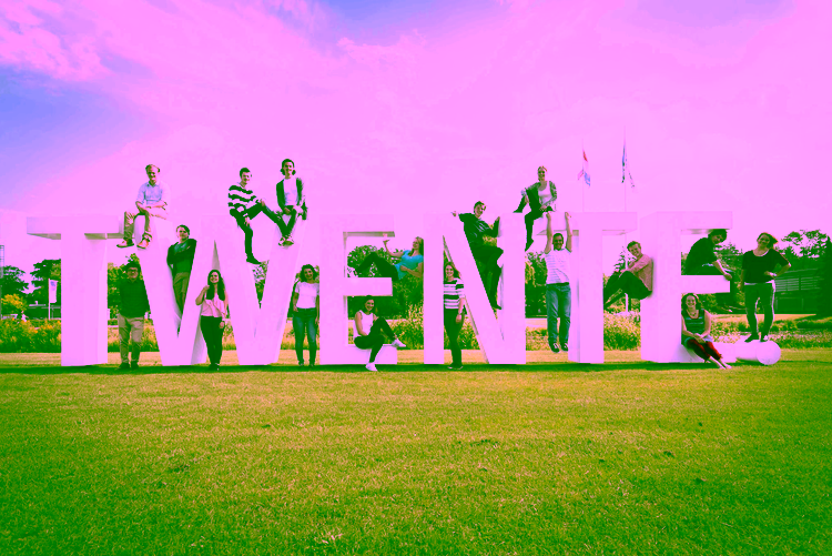 People standing around the letters T W E N T E