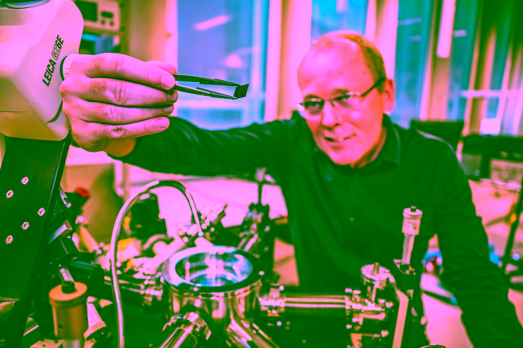 Researcher Hans Hilgenkamp holds chip with tweezers