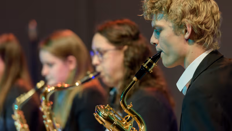 Members of the student orchestra play a song.