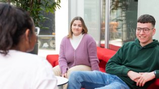 Three Psychology students sitting and talking