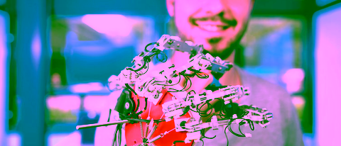 Boy shows a mechanical robotic arm
