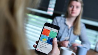 Close-up of a person holding a smartphone with a health app