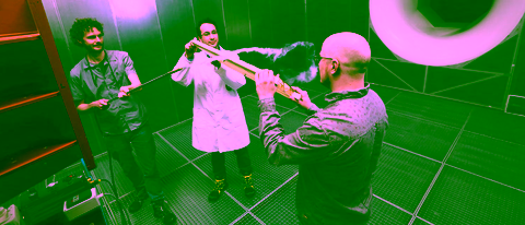 Wind tunnel test with three engineers studying airflow dynamics