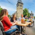 Terrace in Enschede with people and Grote Kerk in the background.