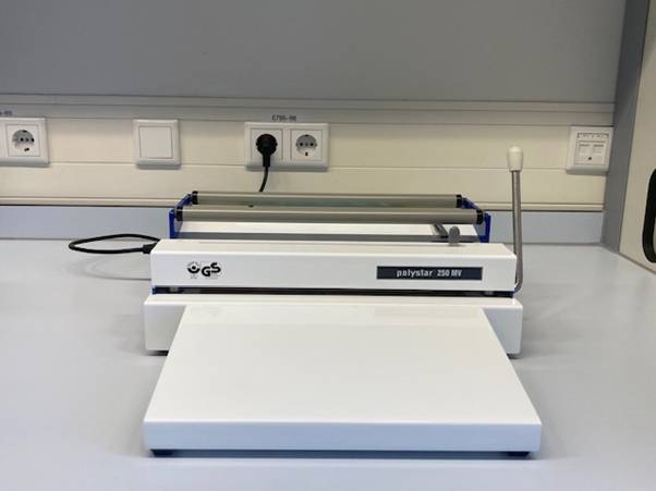 A white machine with a black cordAI-generated content may be incorrect.