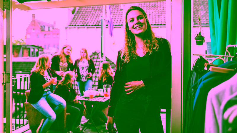 A group of members of a student association are hosting a drink on a roofterrace.