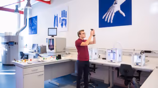 Design lab with 3D printers and prototypes, showcasing user-centered innovation and functional product development.