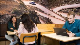 students at table talking and studying