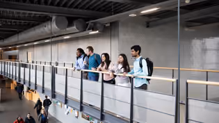 students on a bridge in a high school building