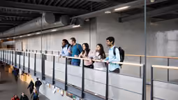 students on a bridge in a high school building