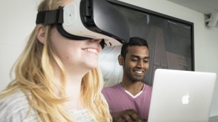 Two students trying out VR-glasses