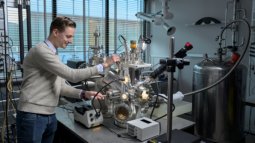Student operates a high-tech setup for materials research in the nanolab.
