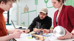 Collaborative work on tech prototype, illustrating the interplay between human interaction, design, and emerging technologies.
