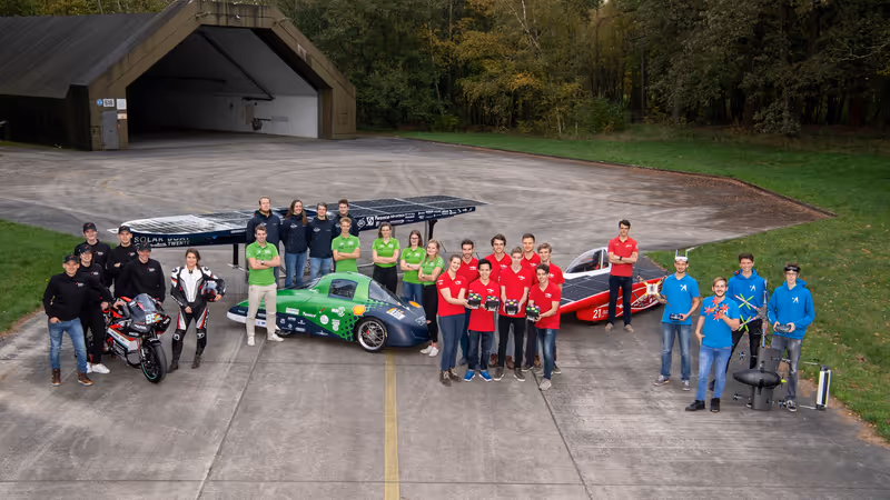 Group picture of five student teams with their vehicles