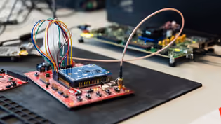 Workspace featuring electronic circuit boards interconnected with colorful wires in a close-up view.