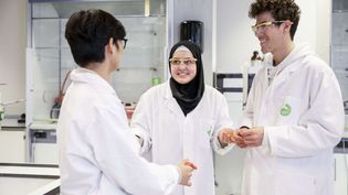 Chemical Science and Engineering students working in lab wearing white coats