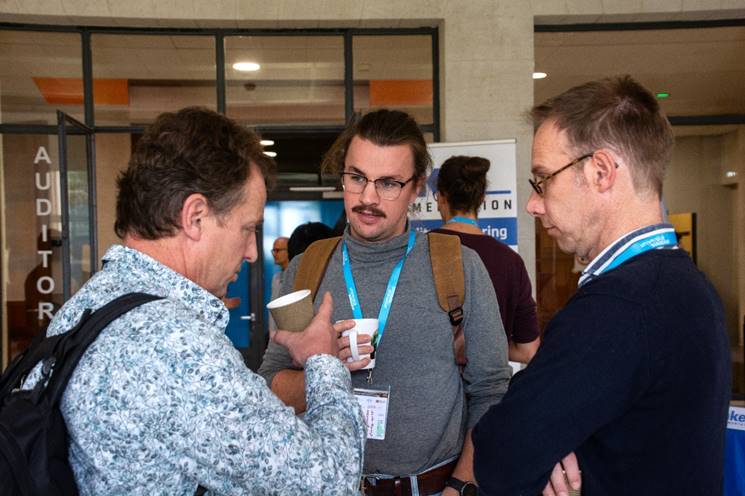 A group of men talking to each other

AI-generated content may be incorrect.